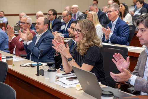 Audience members applaud news about the FedNow Service during an instant payments panel during the 2023 Chicago Payments Symposium.