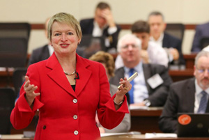 woman in a red jacket presenting