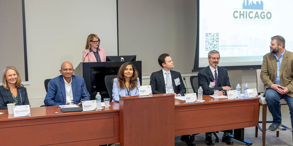 Federal Reserve Bank of Chicago Executive Vice President Shonda Clay stands at the podium to introduce six instant payments panelists at the 2023 Chicago Payments Symposium.